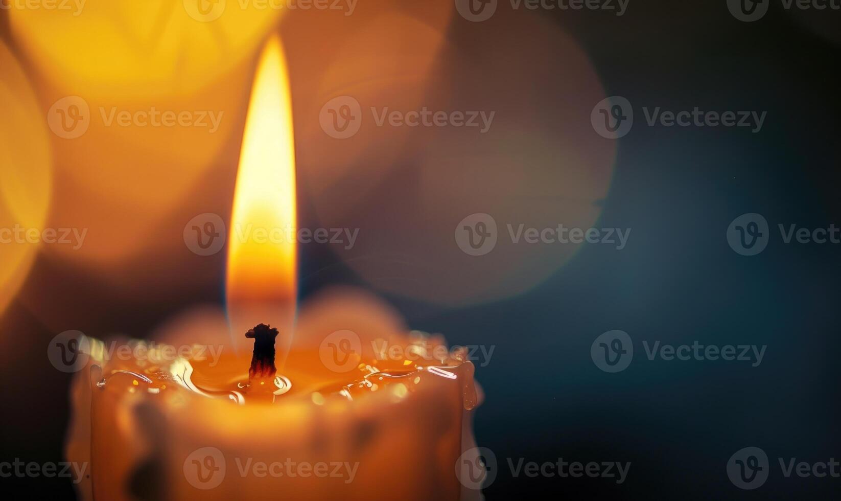 Close-up of a candlewick glowing brightly amidst the darkness photo