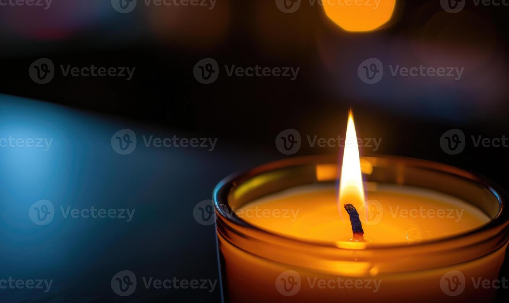 Close-up of a candle's gentle flicker illuminating a serene setting photo