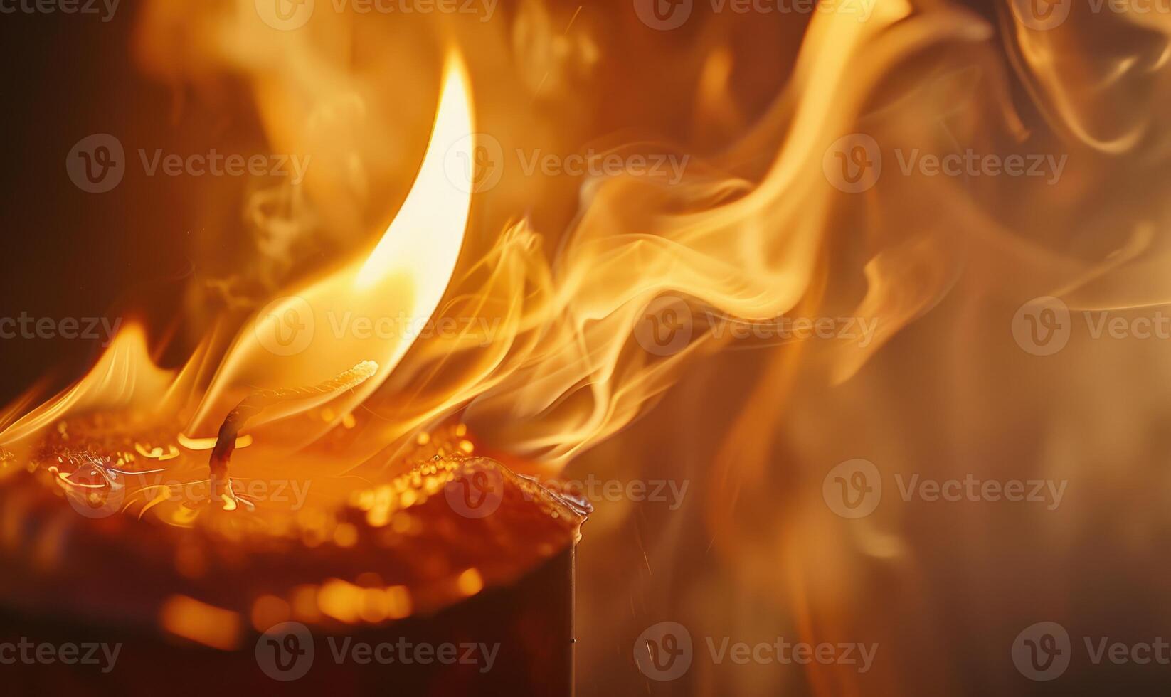 Close-up of a candle flame dancing in the breeze photo