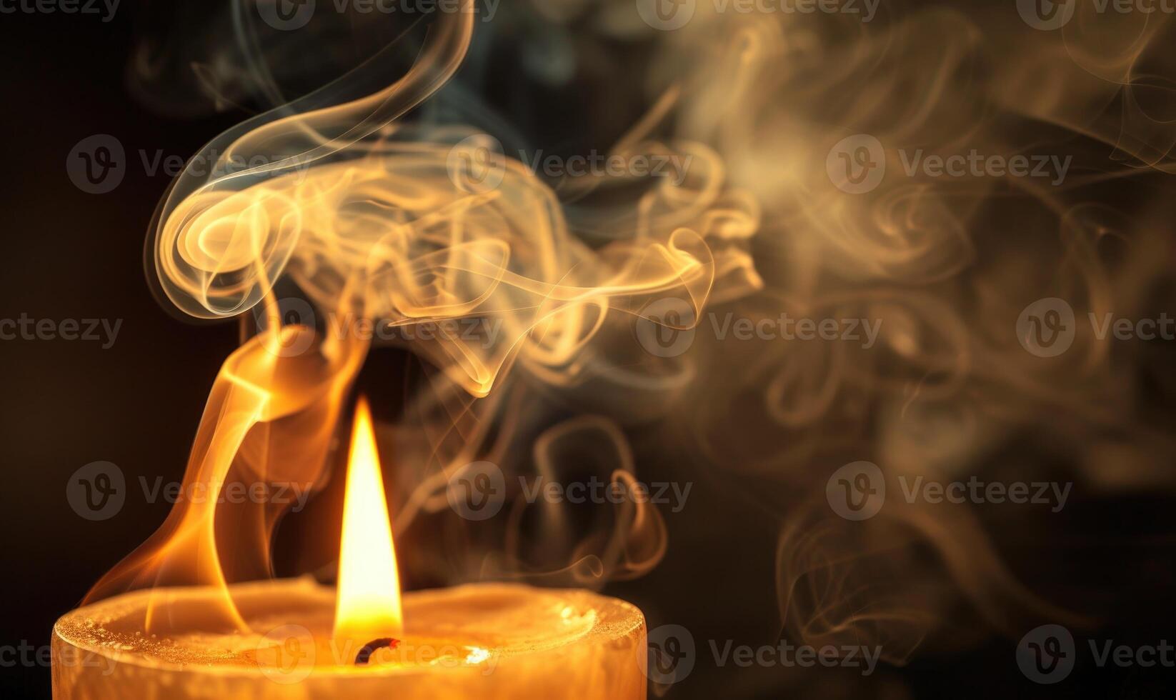 Close-up of a candle with wisps of smoke rising from the flame photo