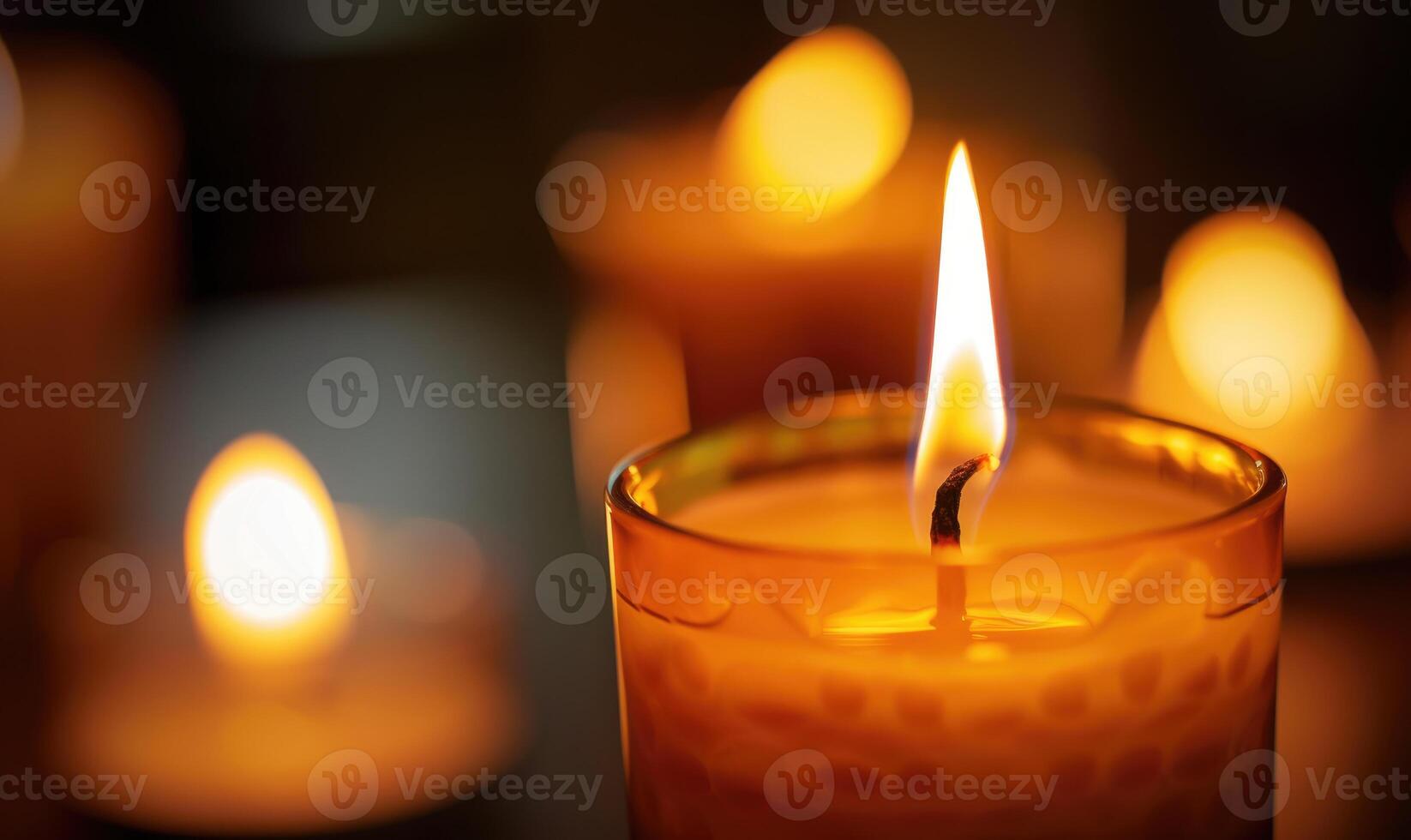 Close-up of a candle burning brightly with soft focus on the flame photo