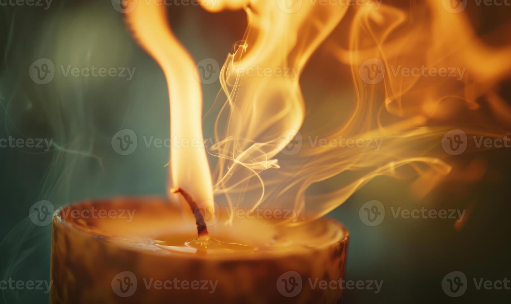 Close-up of a candle flame dancing in the breeze photo