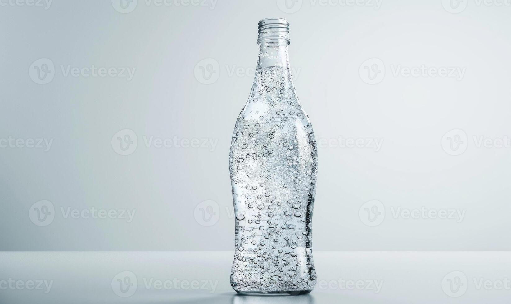 Studio shot of a transparent glass bottle mockup filled with premium quality sparkling water photo