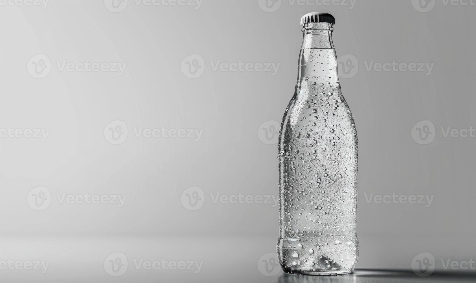 Studio shot of a transparent glass bottle mockup filled with premium quality sparkling water photo