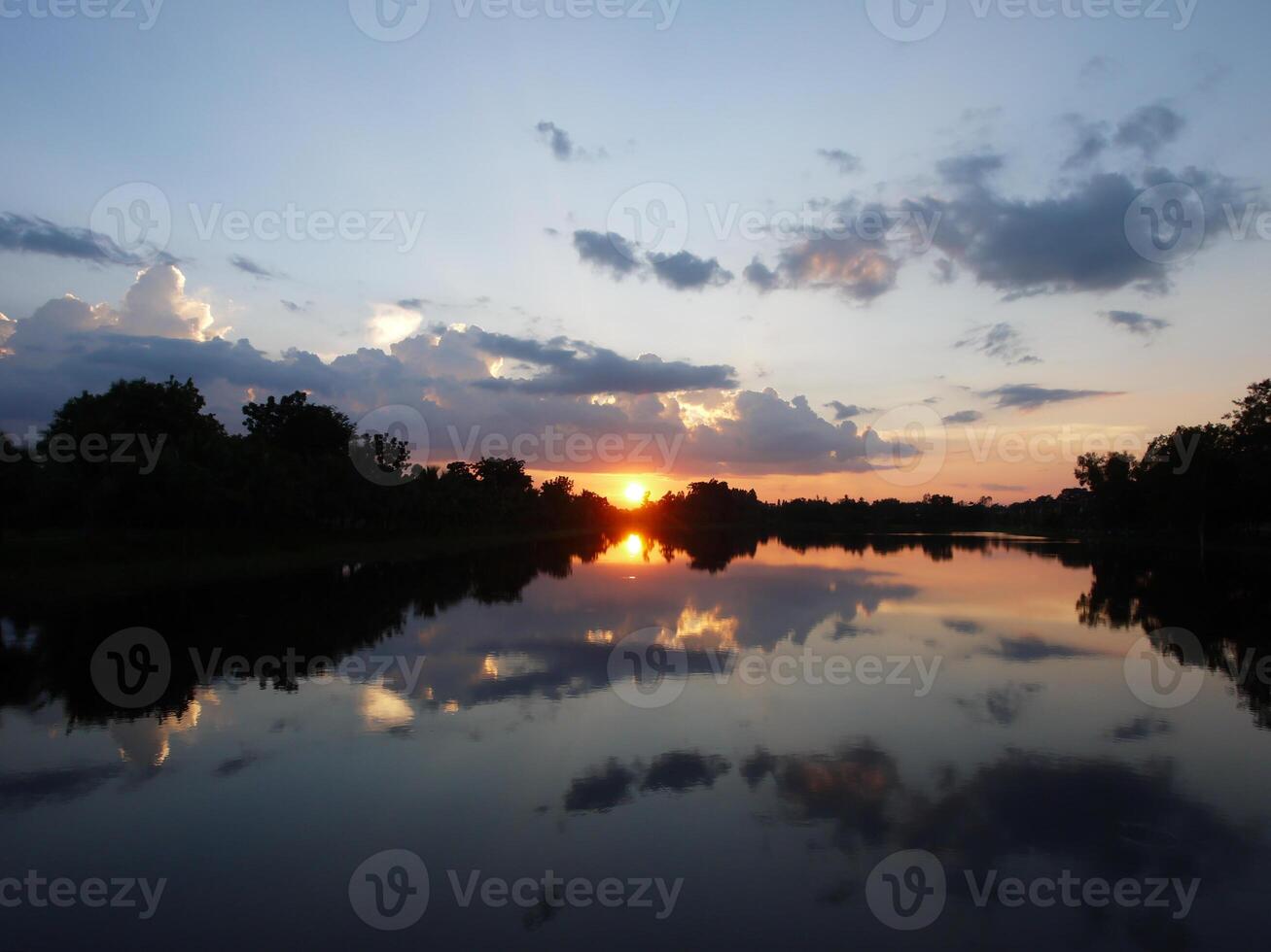 Spectacular sunset over, orange sun rising up over the horizon photo