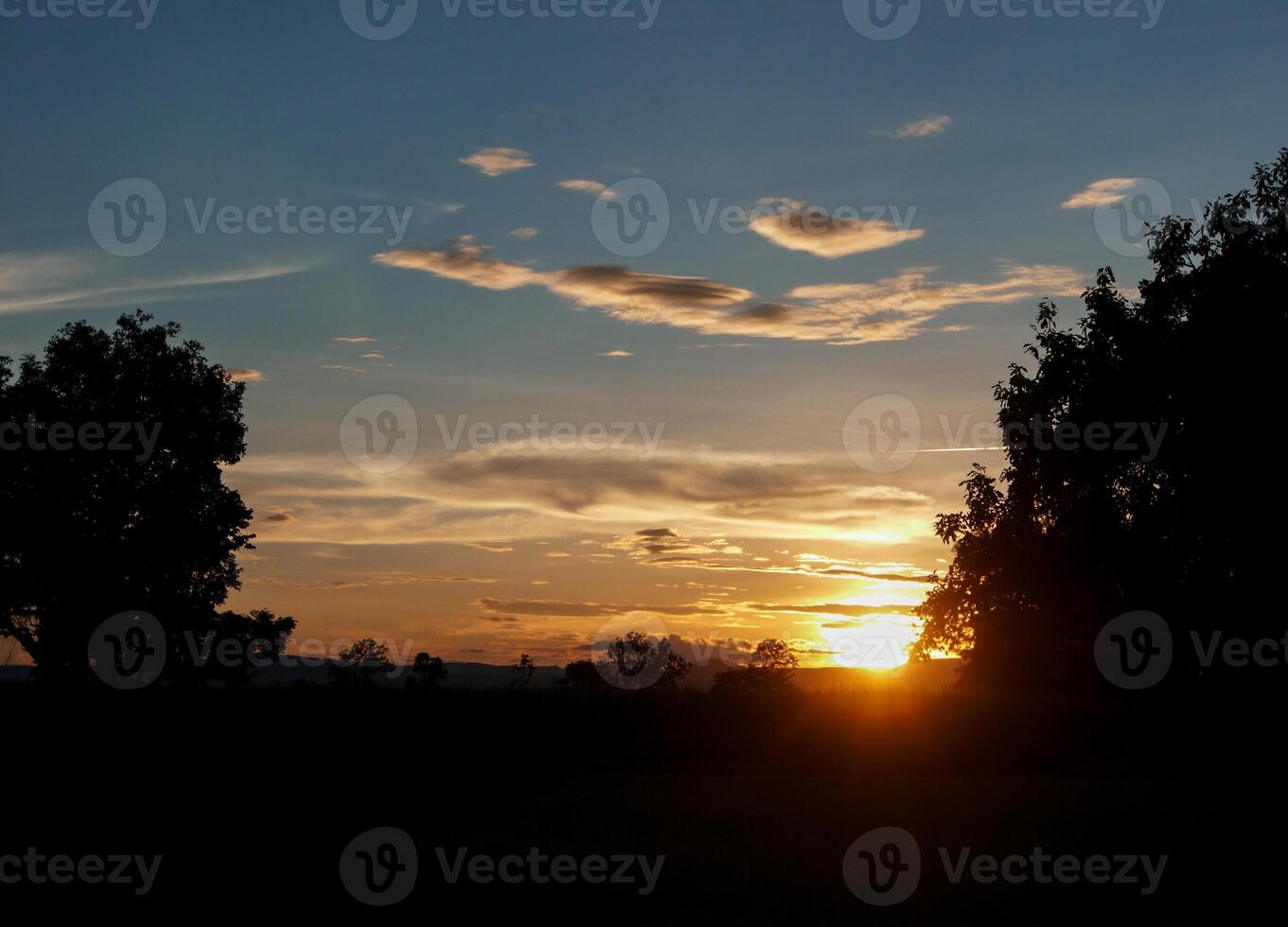 Spectacular sunset over, orange sun rising up over the horizon photo