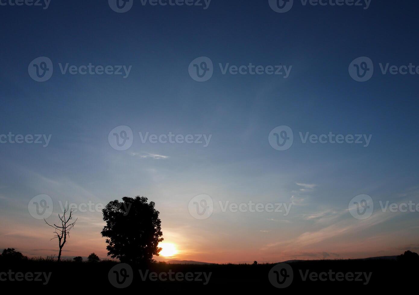 Spectacular sunset over, orange sun rising up over the horizon photo