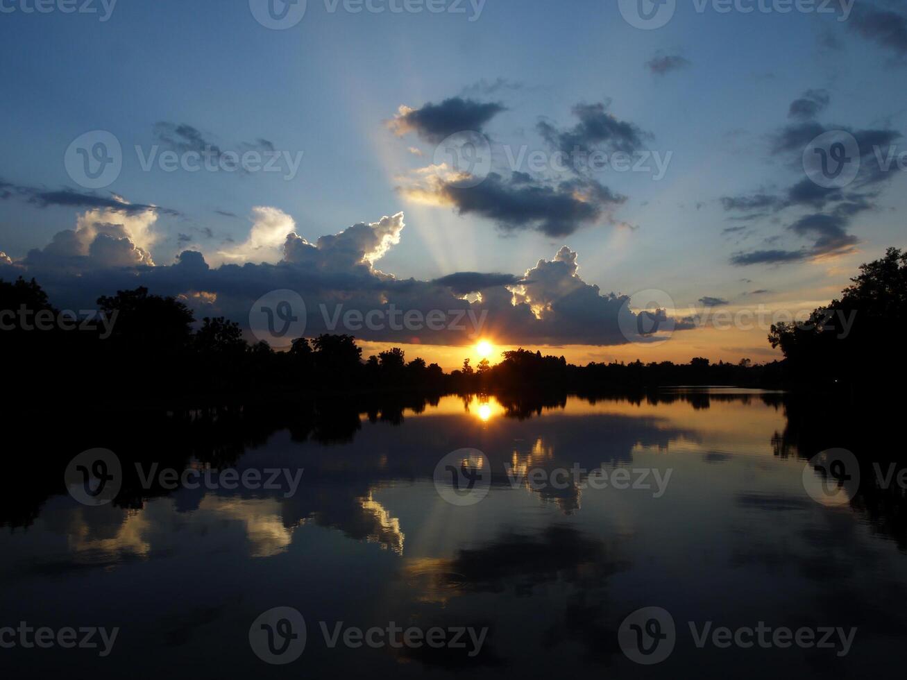 Spectacular sunset over, orange sun rising up over the horizon photo