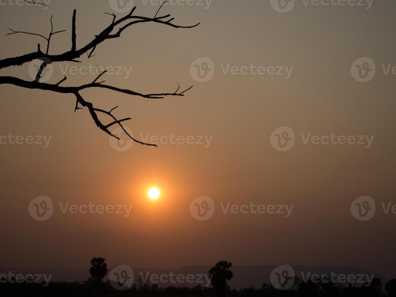 Spectacular sunset over, orange sun rising up over the horizon photo