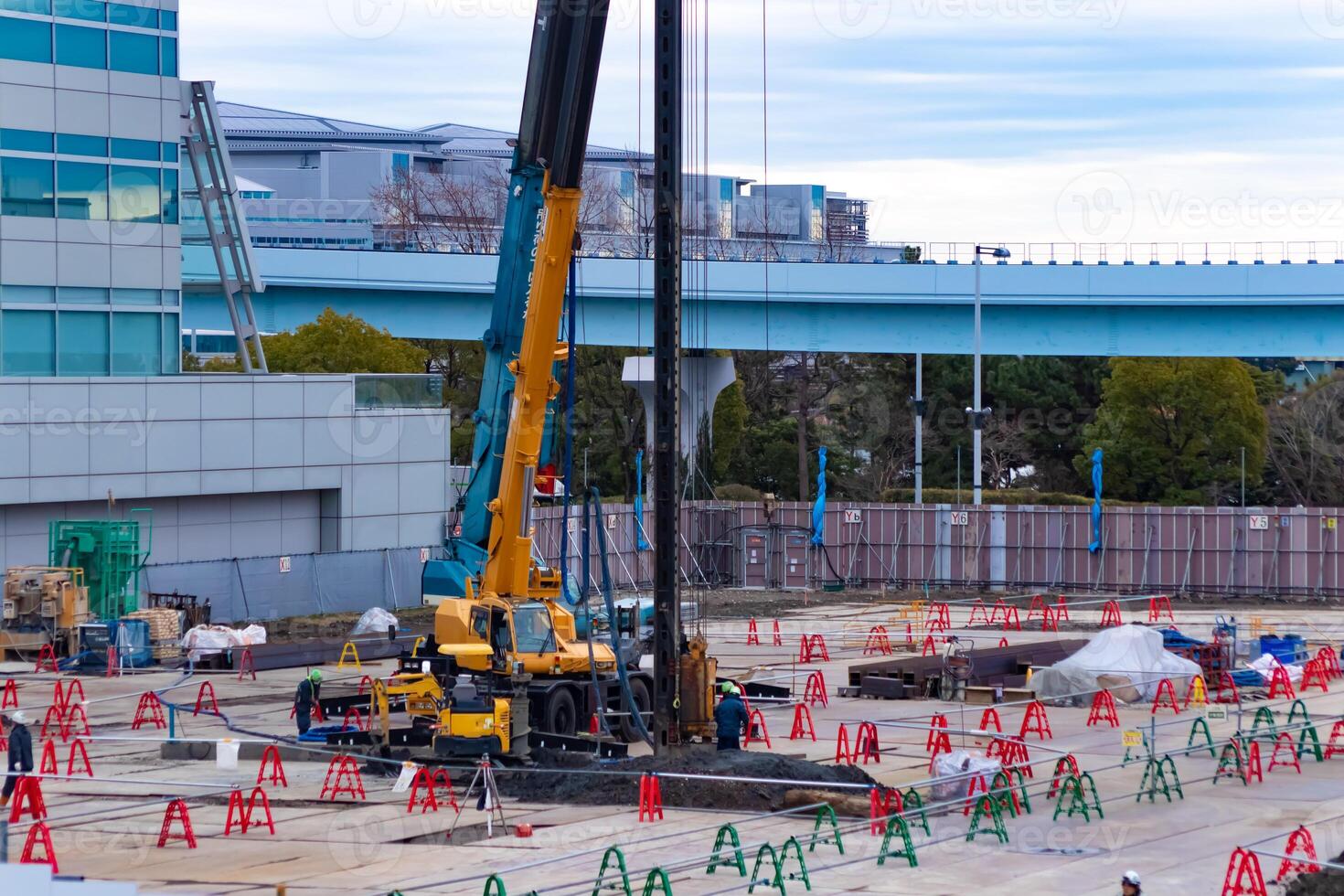 Cranes at the under construction near the railway telephoto shot photo