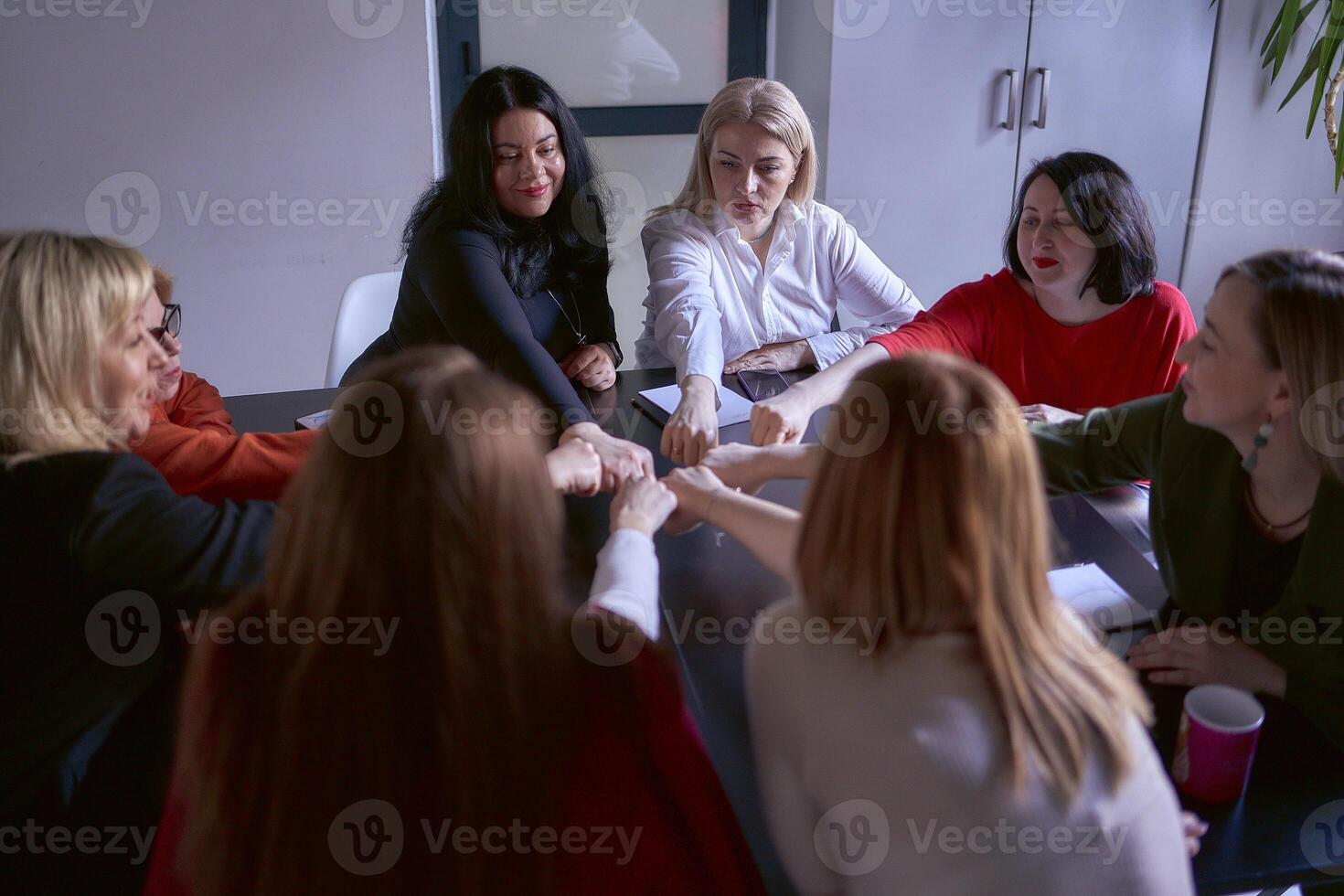 team members in the office congratulate each other on a good job and the completion of the project photo