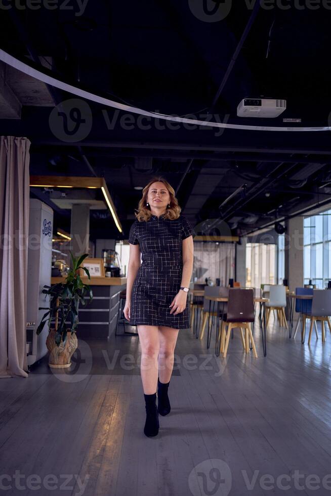 stunning model in business mini dress catwalk in modern office space photo
