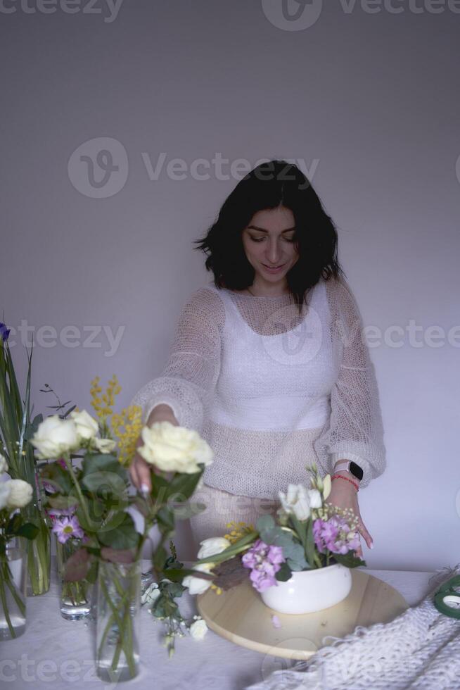 female florist make decorations and floral arrangements for Easter photo