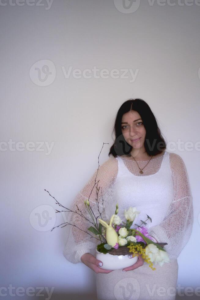 female florist make decorations and floral arrangements for Easter photo