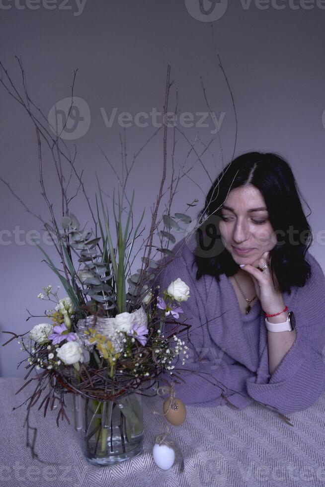 female florist make decorations and floral arrangements for Easter photo