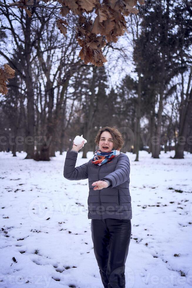 woman play with snow in forest photo