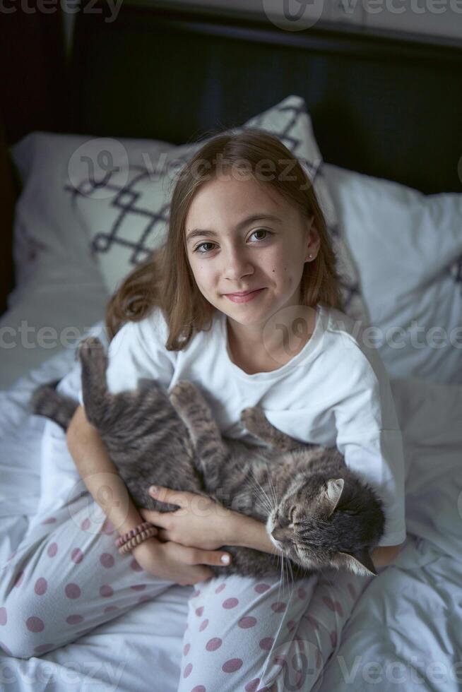 girl plays with a cat photo