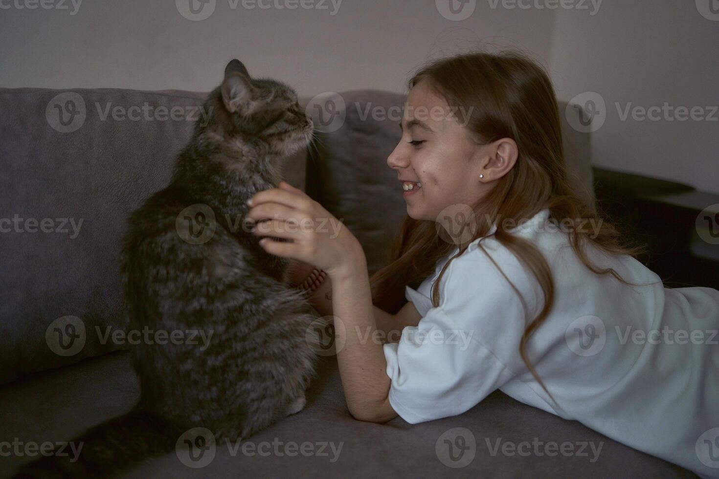 girl plays with a cat photo
