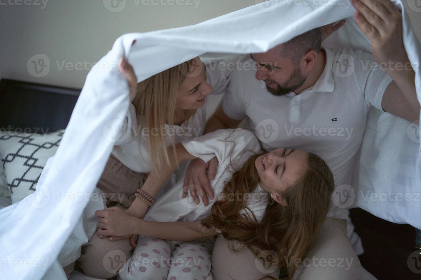 parents play with their daughter photo