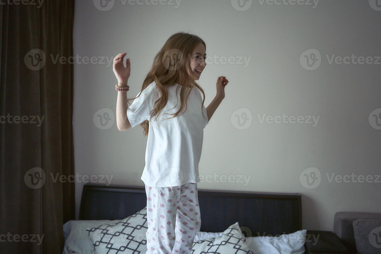 girl jump on a bed photo