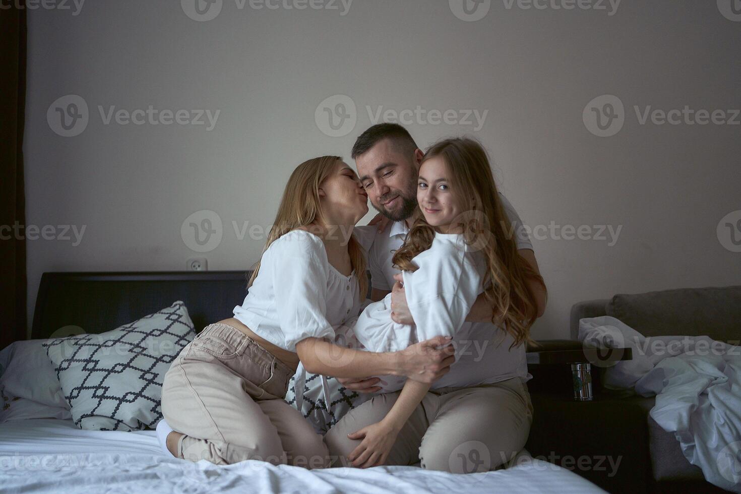 parents play with their daughter photo