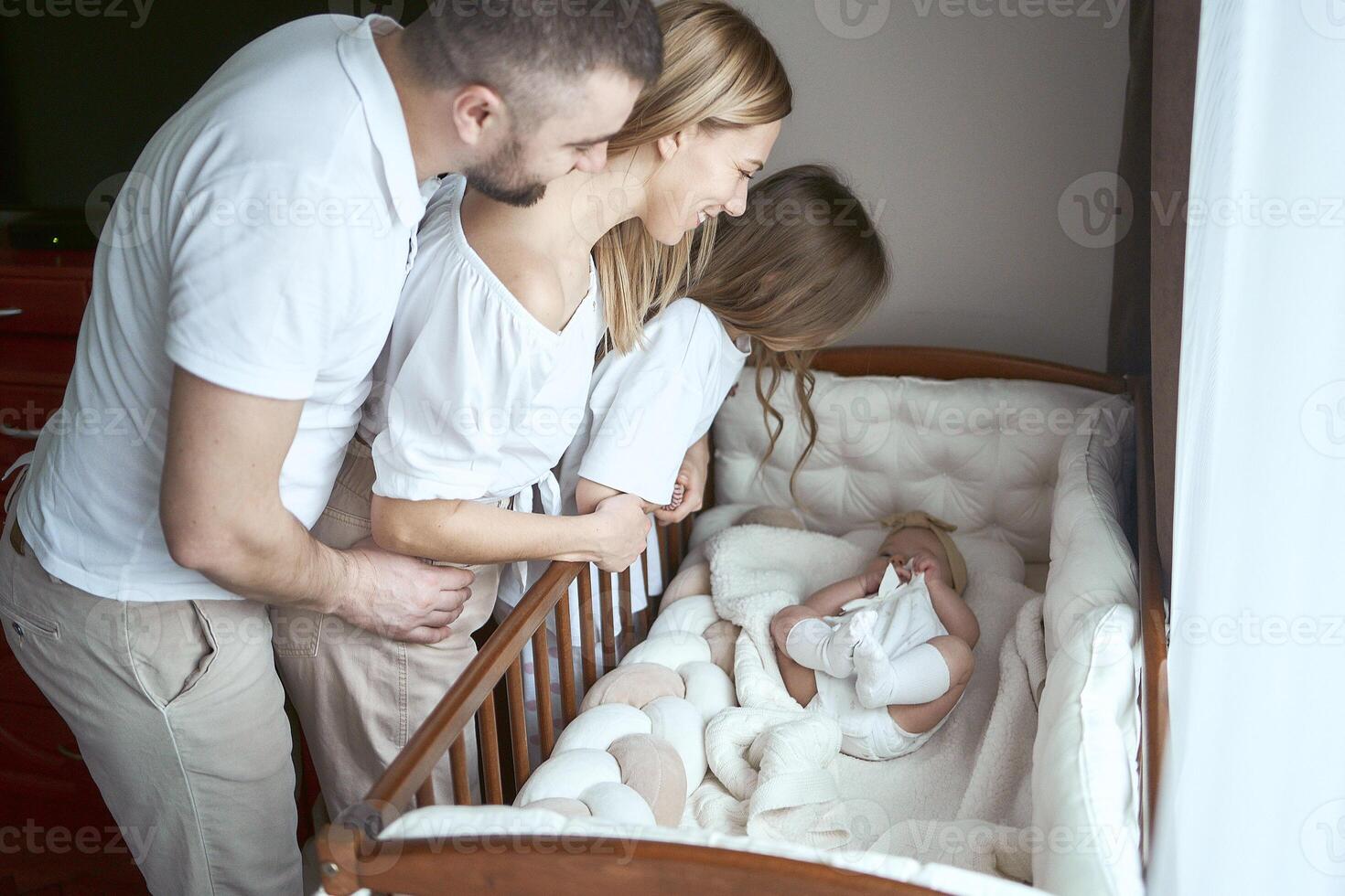 parents comfort their child in a cradle photo