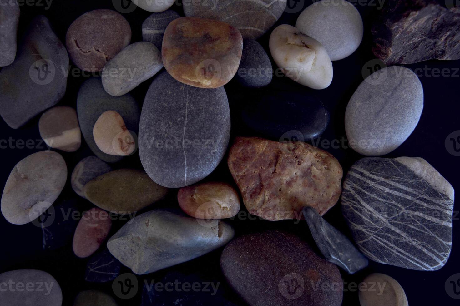 texture of sea pebbles on a black background photo