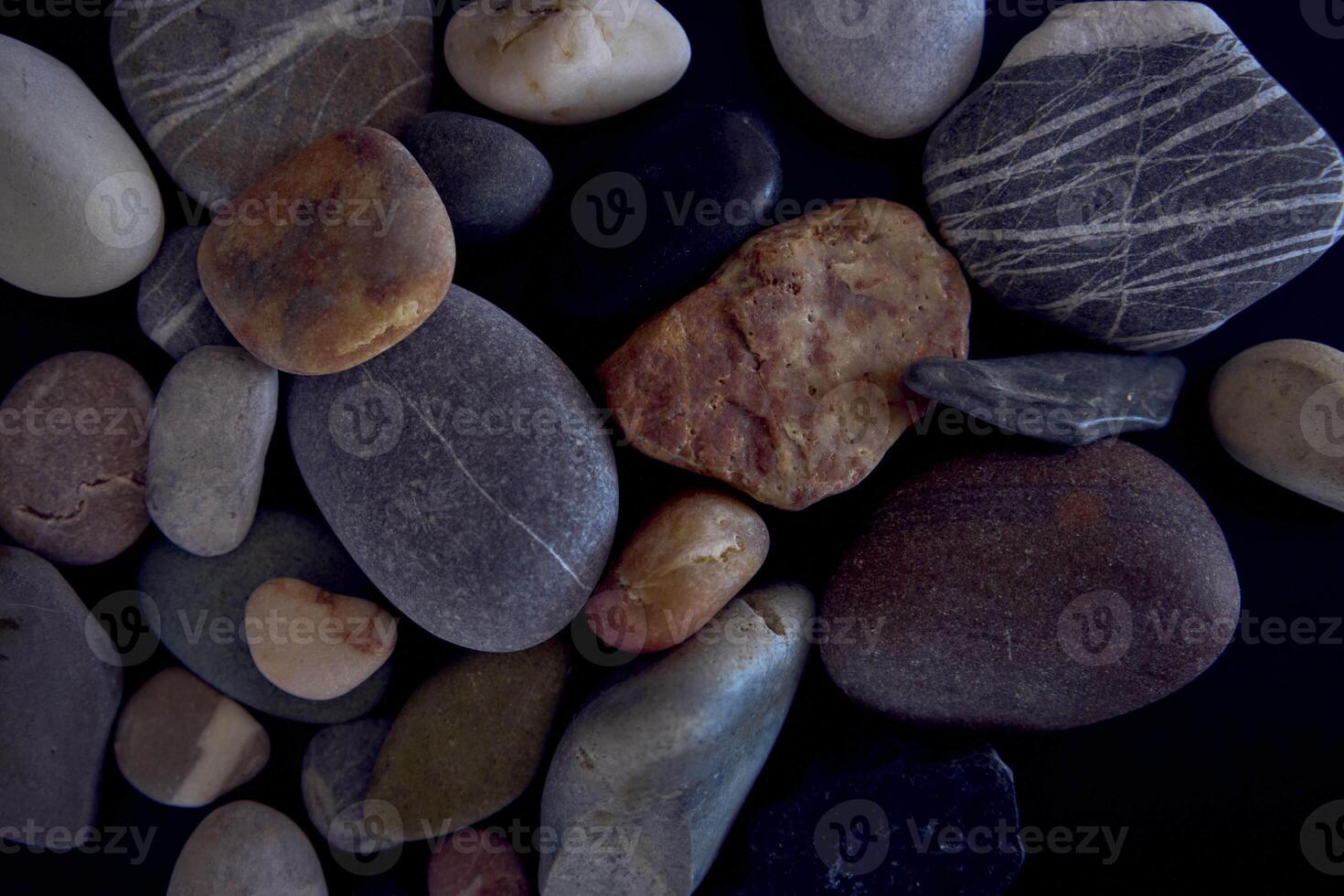 texture of sea pebbles on a black background photo