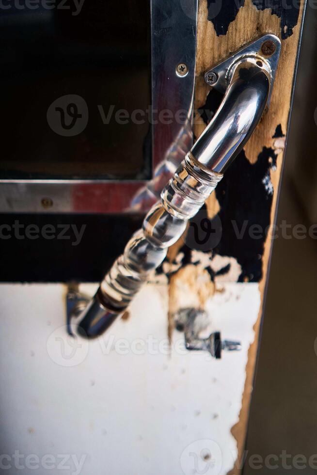 a clear glass handle on a ship's sliding door photo