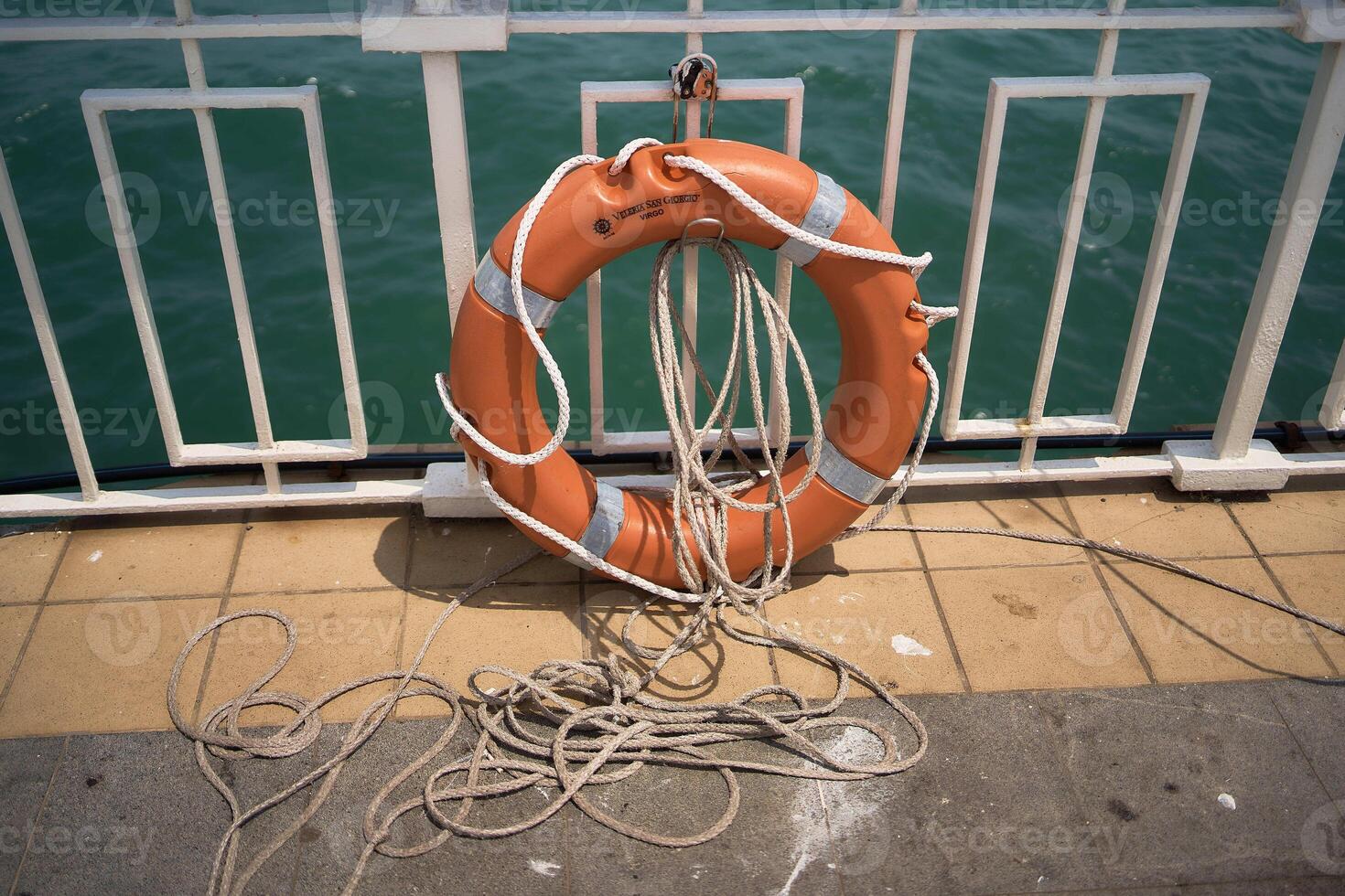 lifebuoy with a rope on the pier photo