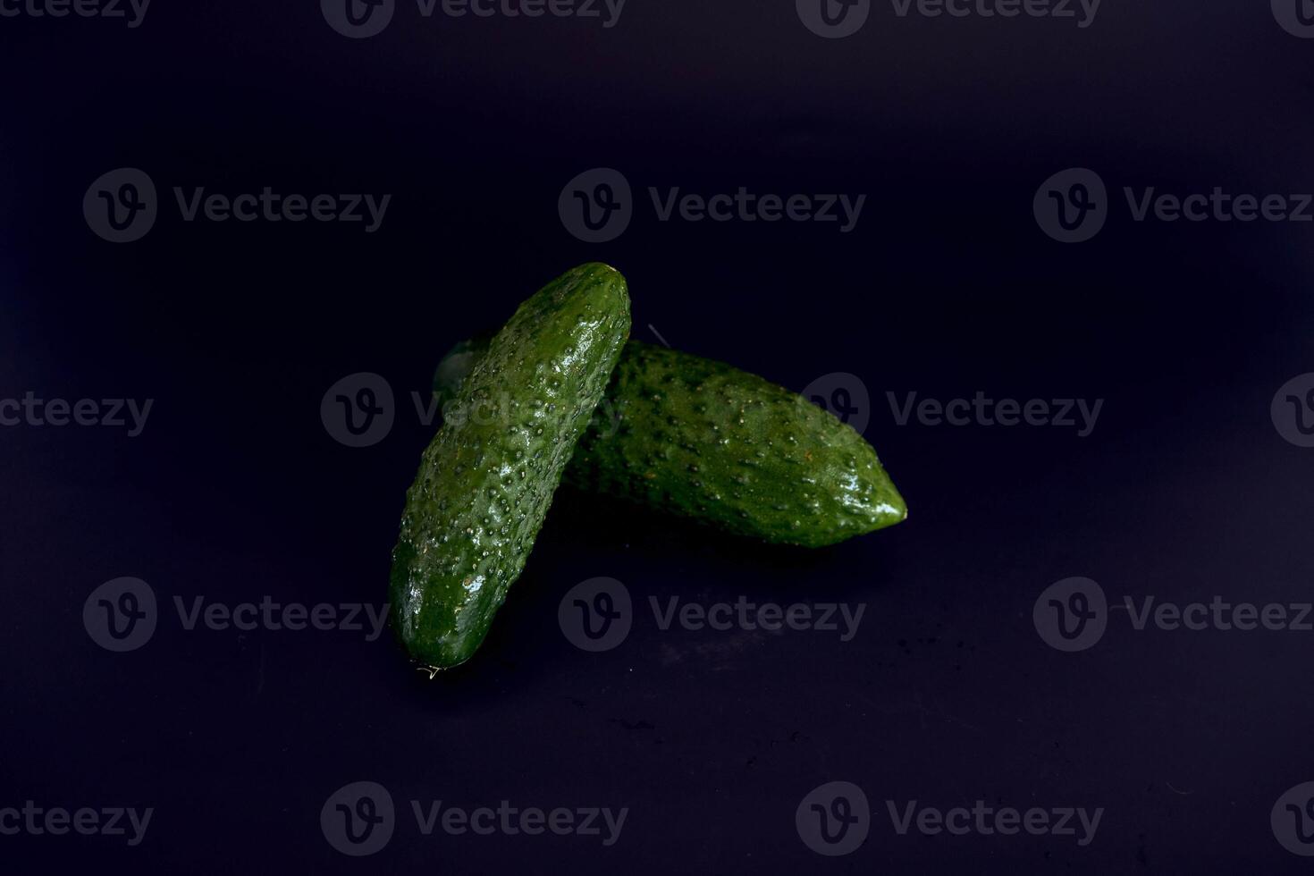 fresh green cucumber on a black background photo