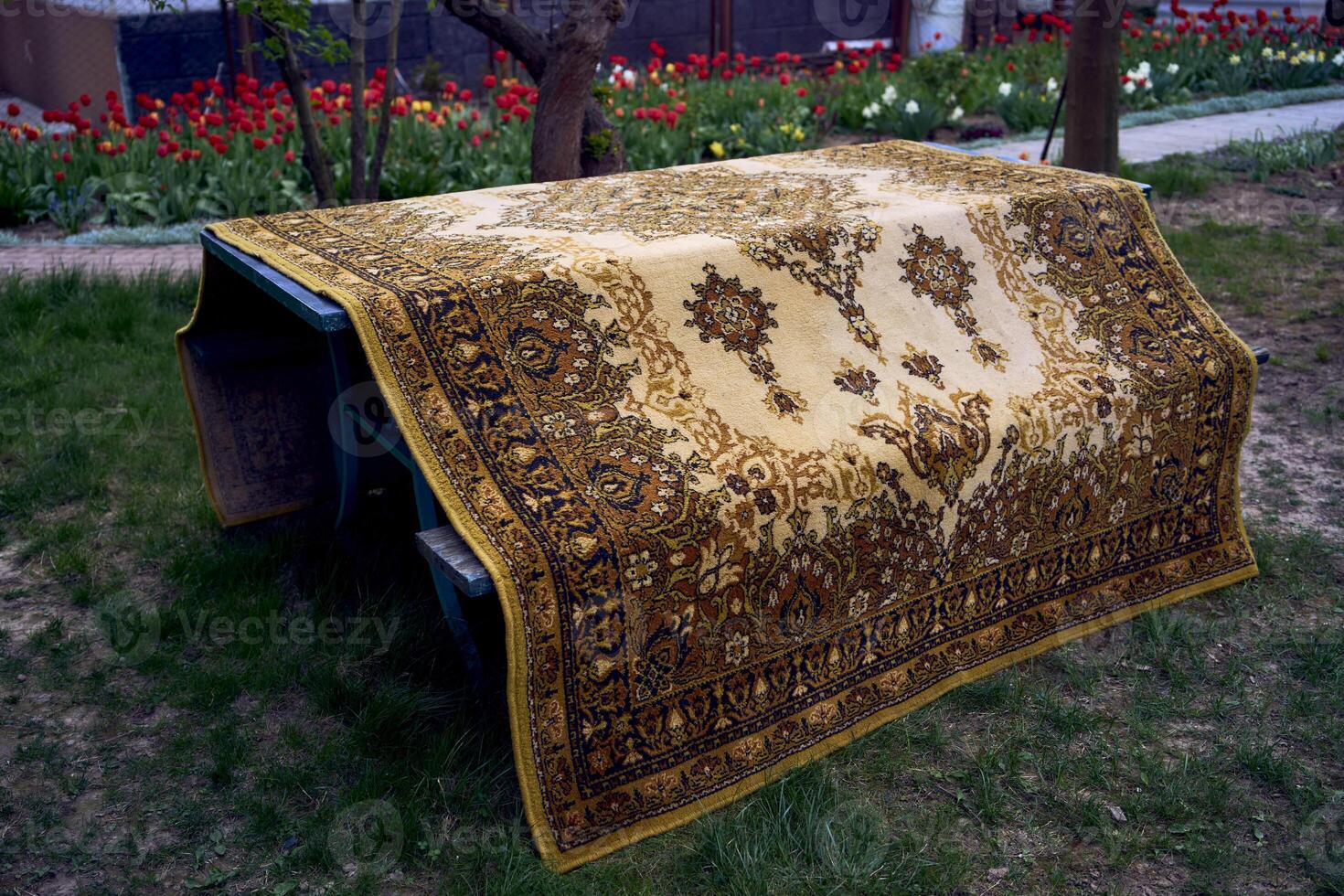 the rug is dried on a table outside after cleaning photo