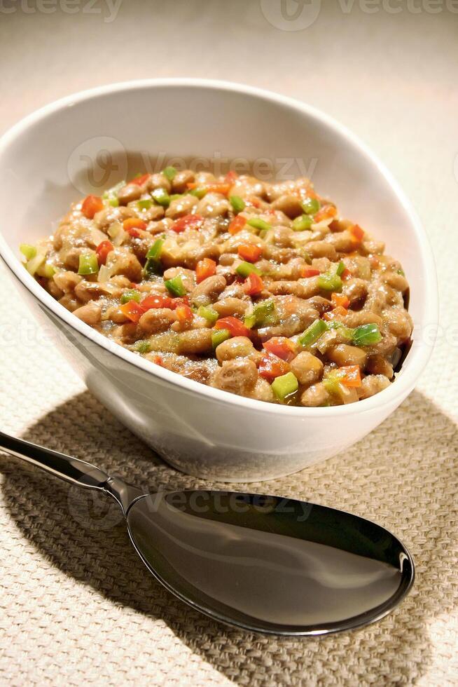 bean salad with chopped tomatoes, peppers, chopped onions and olive oil photo