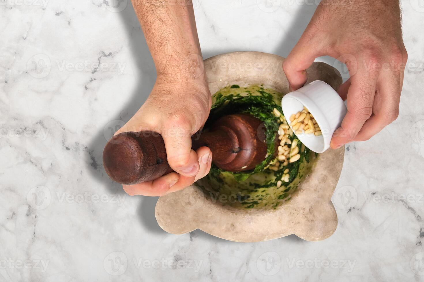 step by step of Italian pesto sauce, with fresh basil, walnuts and grated parmesan cheese. photo