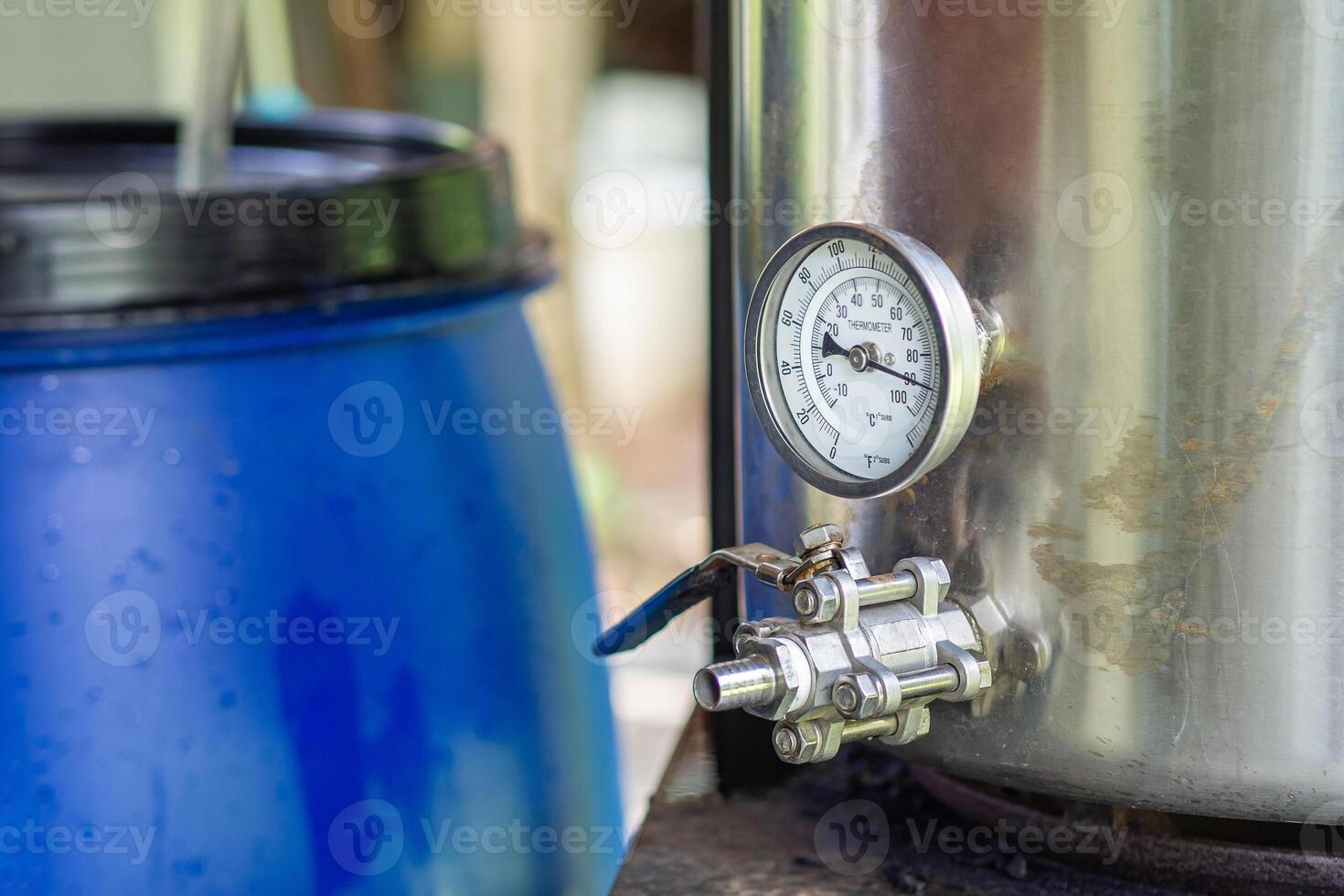 Close-up of alcohol thermometer on craft beer tank. Selective focus. Home brewing process photo