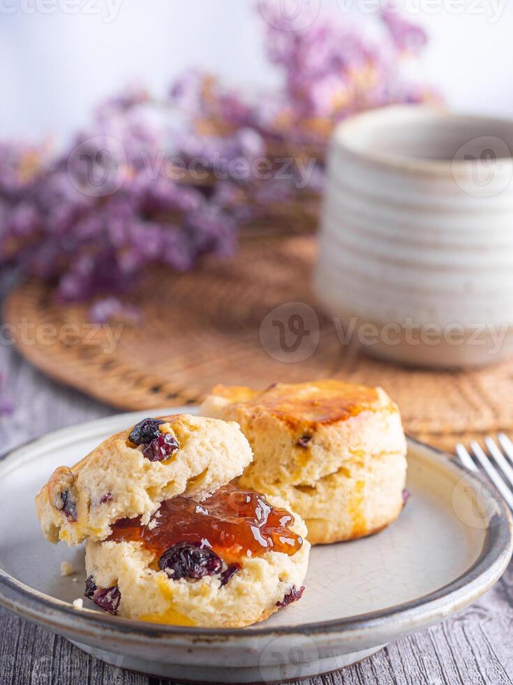 Close-up of traditional British scones on a plate and a tea hot cup with blurred background. Space for text photo