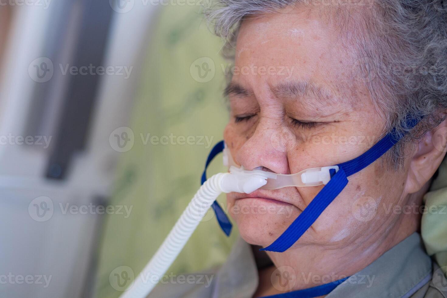 Close-up of senior woman patients with lung disease, getting oxygen for treatment in the room at the hospital. Space for text. Concept of aged people and healthcare photo