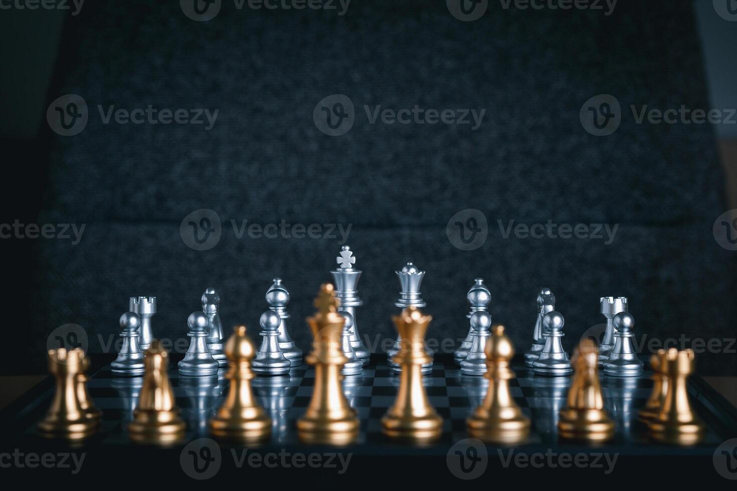 Front view of a chess game on a chessboard with blur foreground. Business game competitive strategy. Concept of strategy for business photo