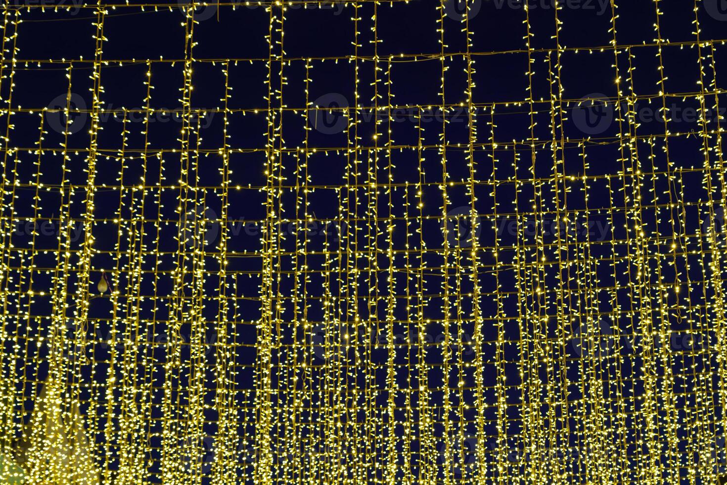 Festive hanging LED garlands against the background of the night sky. photo