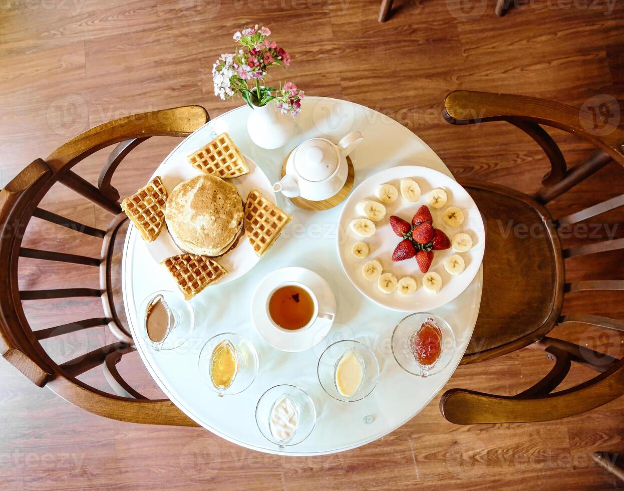 White Table With Plate of Food photo