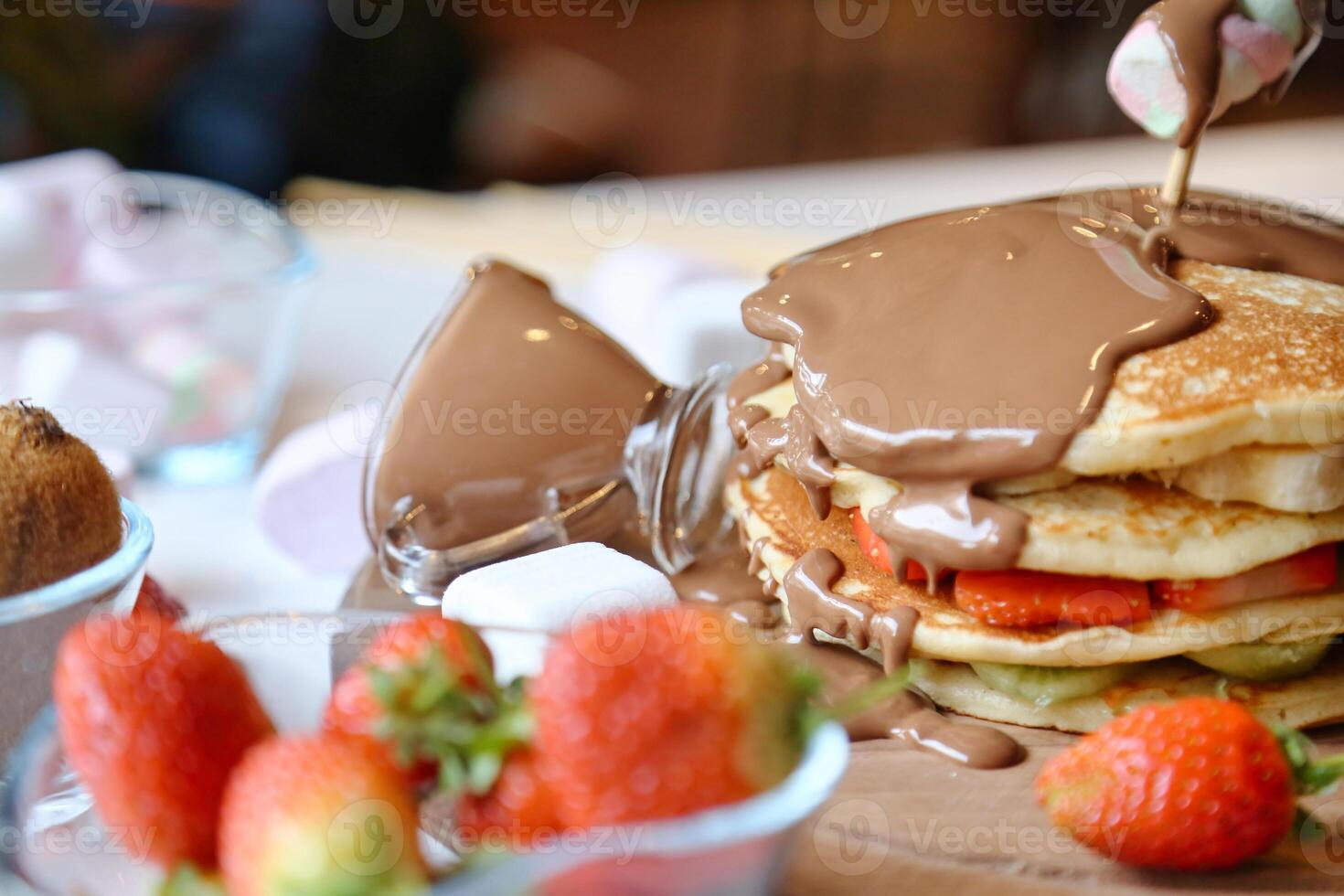 Stack of Pancakes With Chocolate Sauce and Strawberries photo