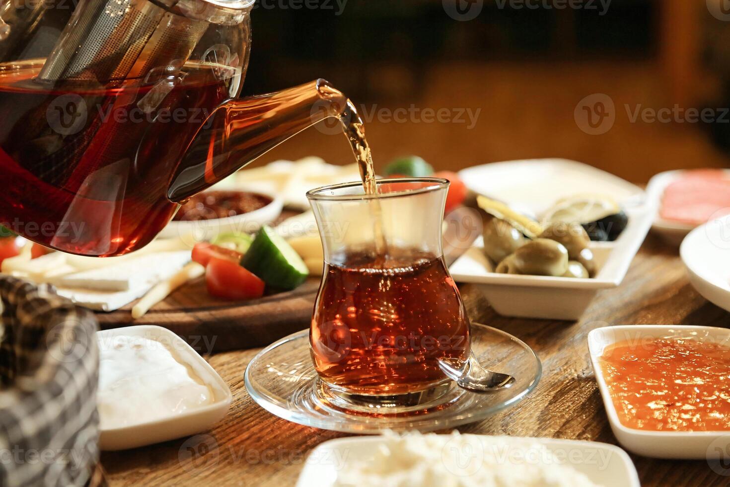 Pouring Freshly Brewed Iced Tea From a Pitcher Into a Glass photo