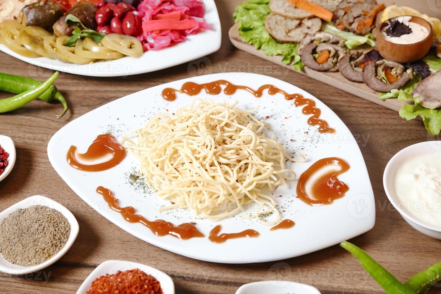 Colorful Plated Food With Savory Sauces on a Table photo