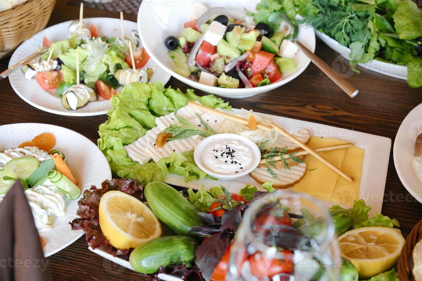 Wooden Table Displaying Plates of Delicious Food photo