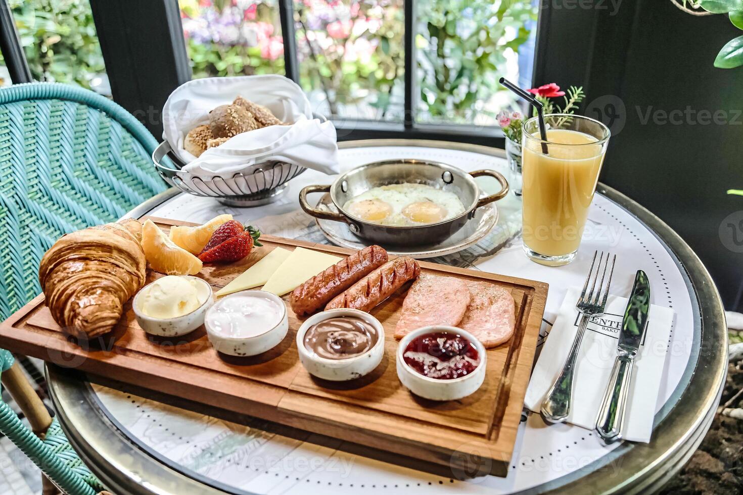 Table Setting With a Plate of Food and Glass of Orange Juice photo