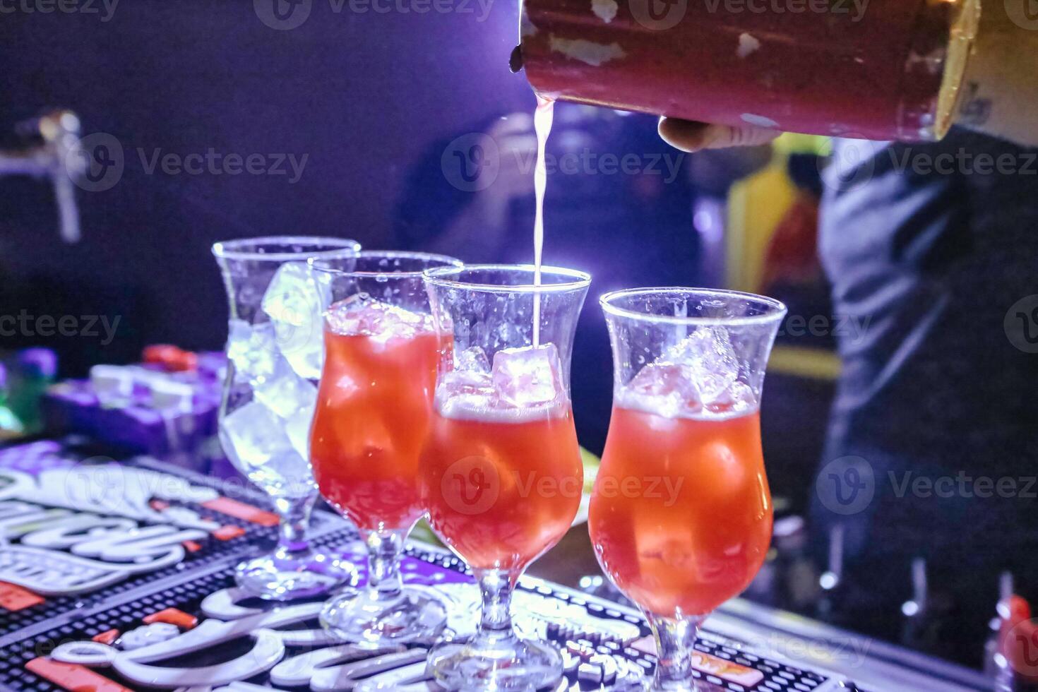 Person Pouring Drink Into Three Glasses photo