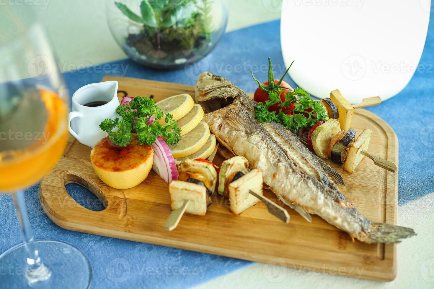 Delightful Platter of Food and a Glass of Wine on a Table photo