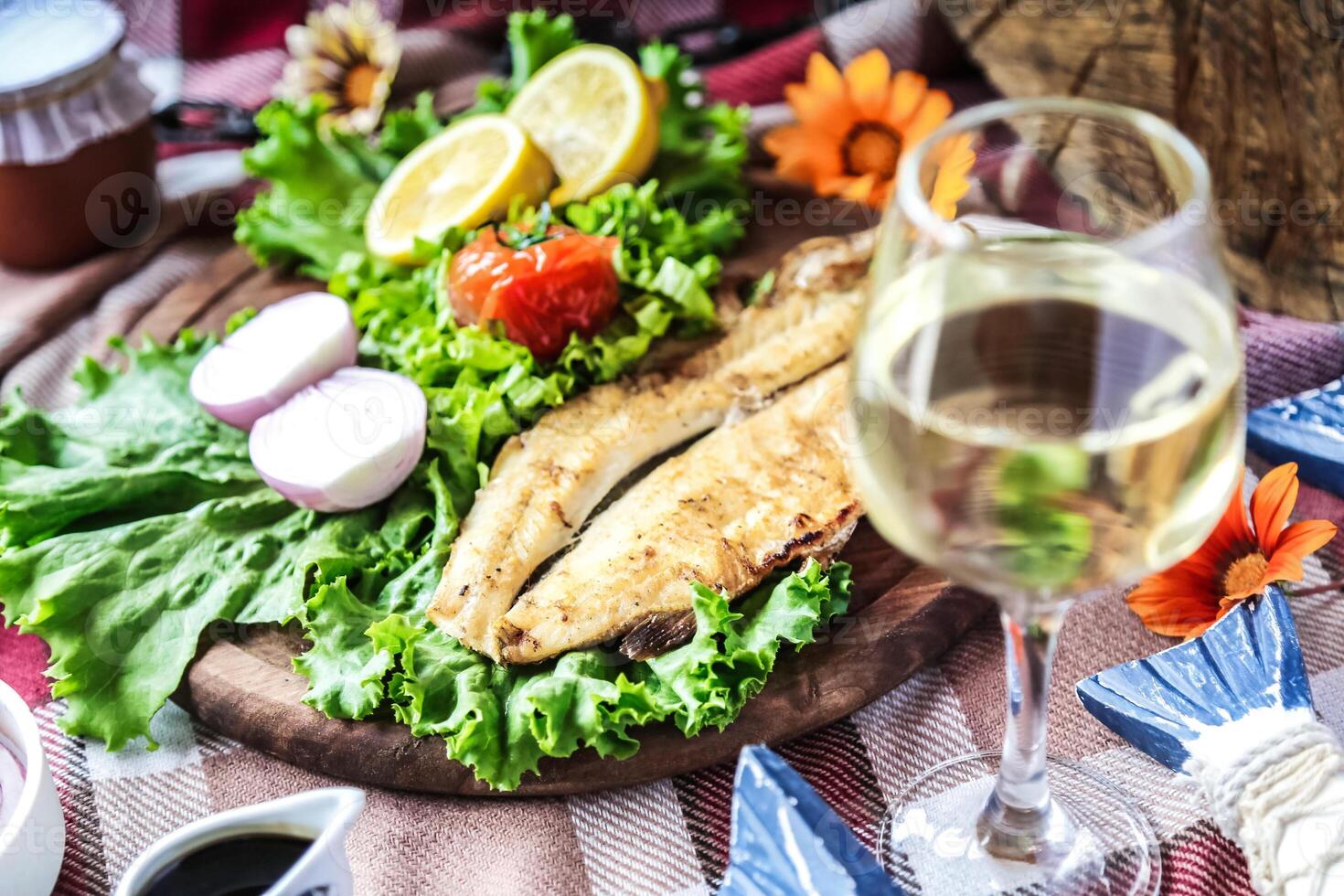 Elegant Meal Plate of Food and Glass of Wine on Table photo