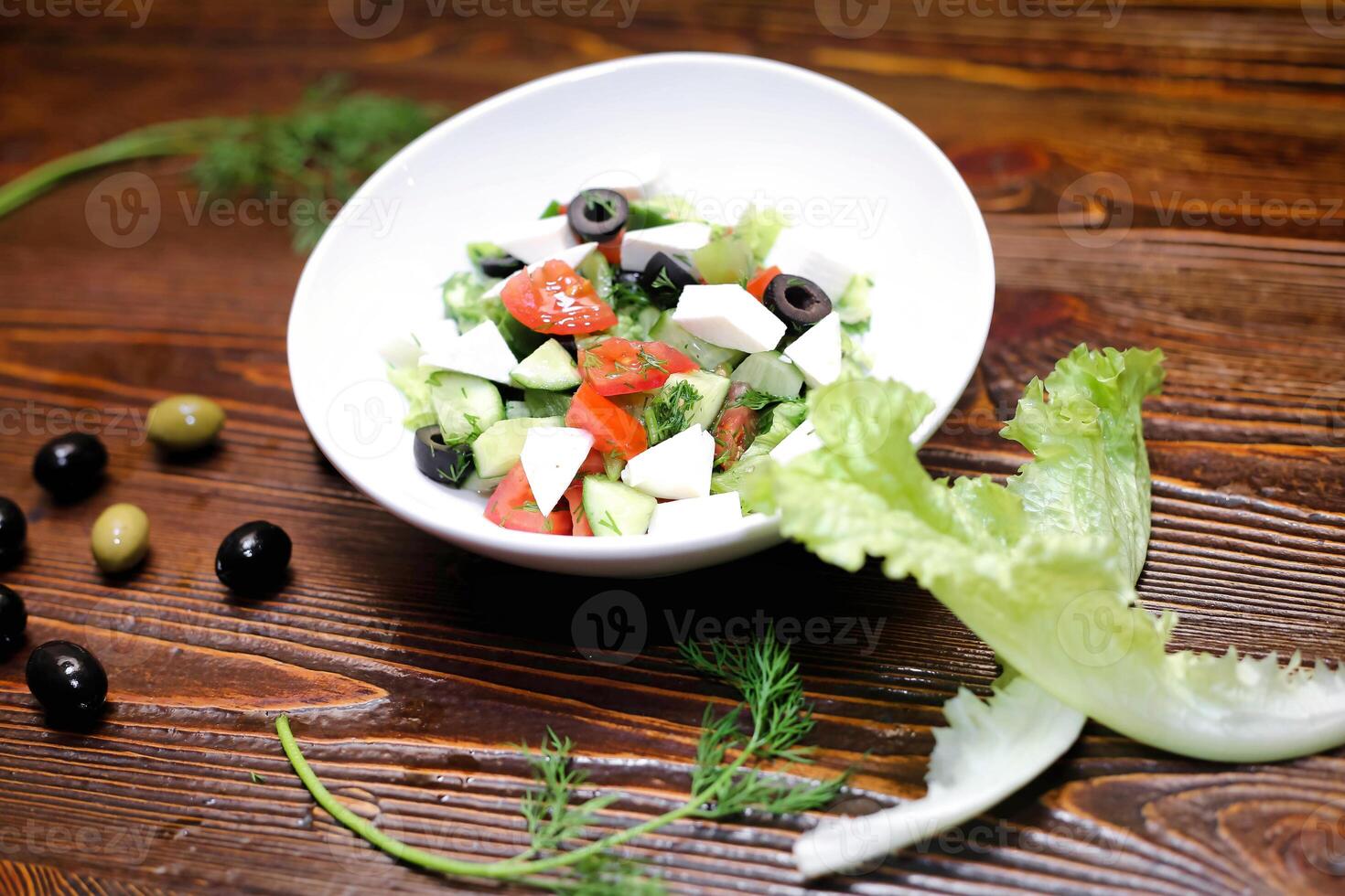 White Bowl Filled With Salad on Wooden Table photo