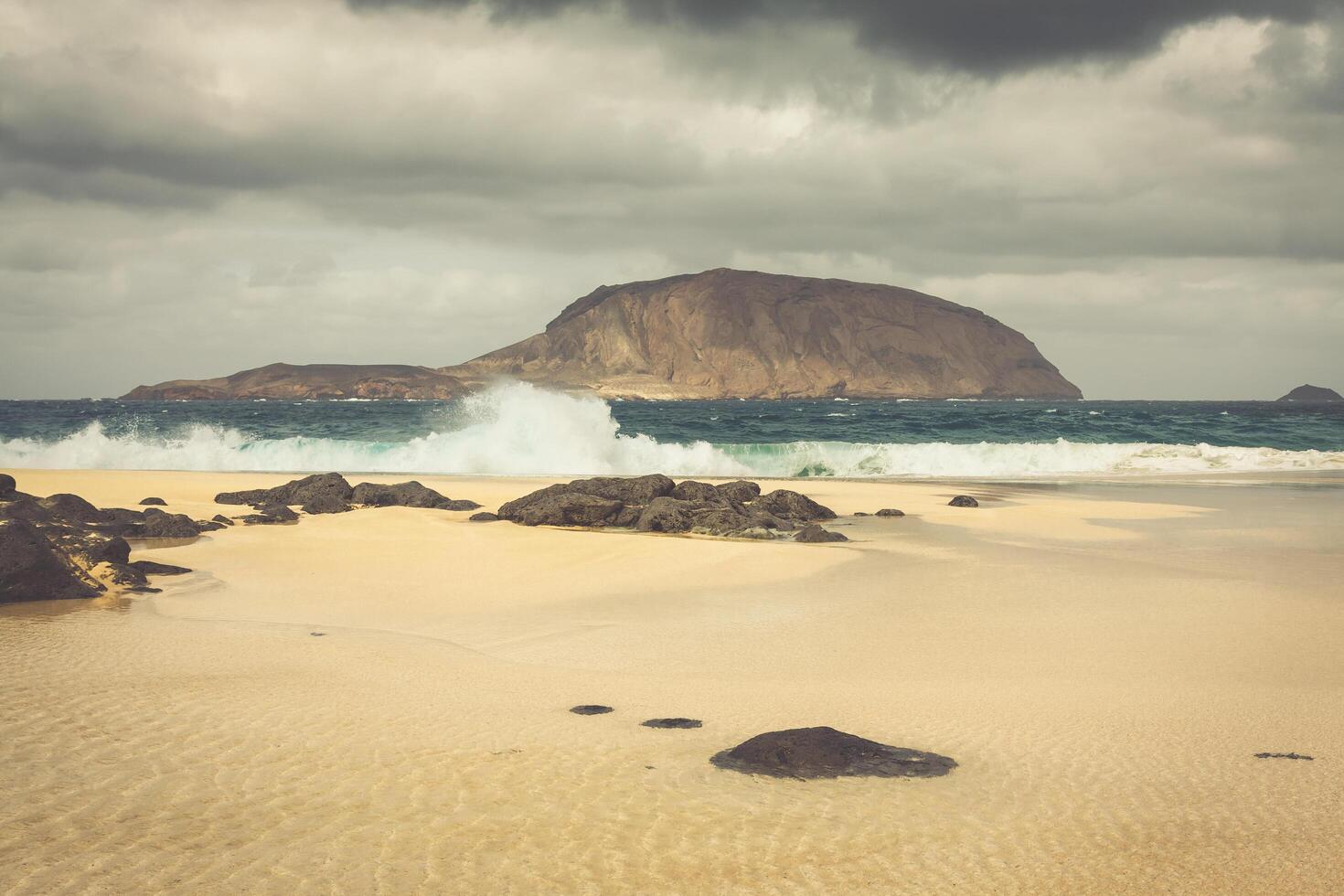 A view of Playa de Las Conchas, a beautiful beach on La Graciosa, a small island near Lanzarote, Canary Islands, in the middle of the Atlantic Ocean. photo